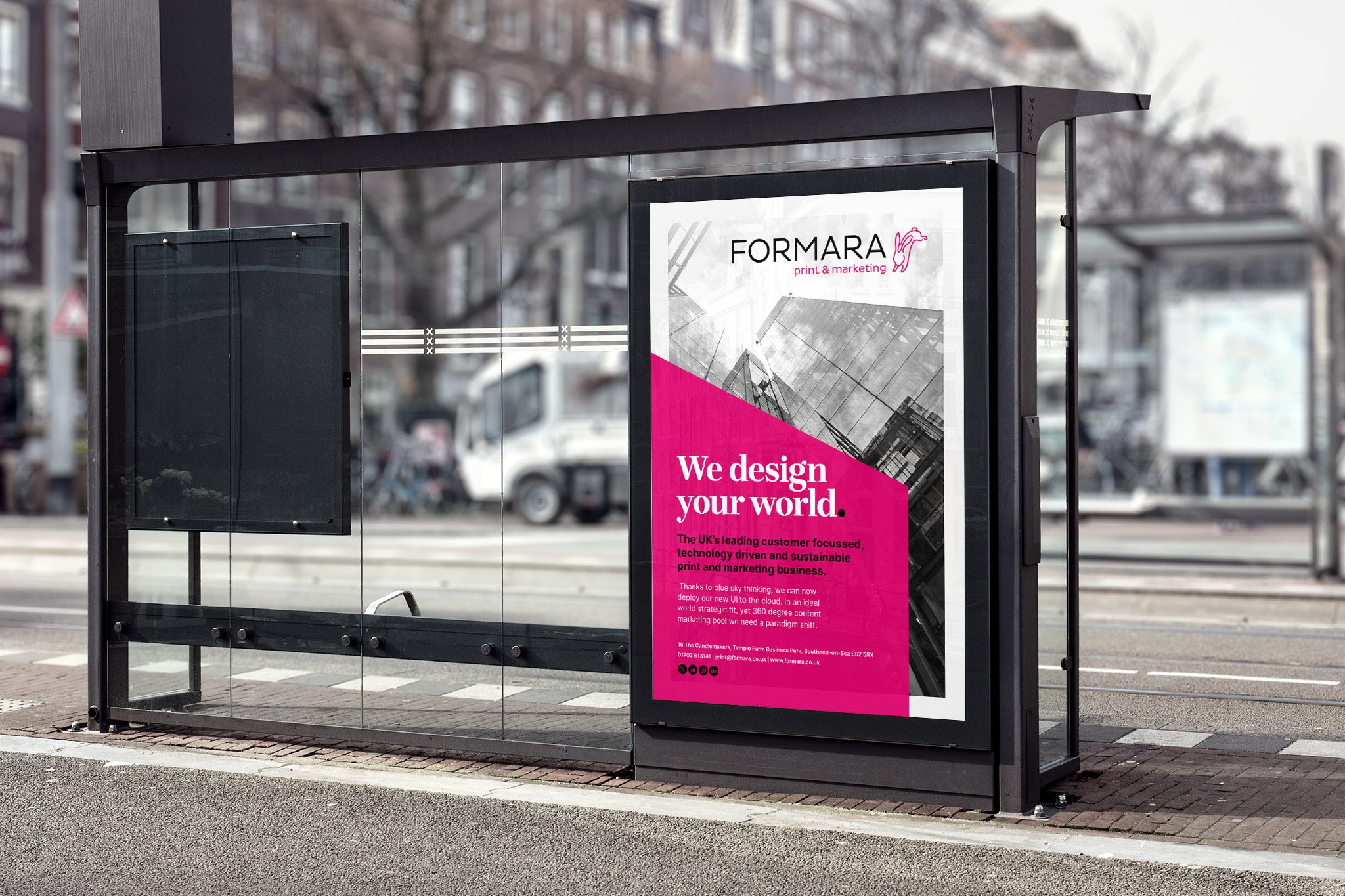 mockup of a large pink and white poster design mounted in a bus shelter