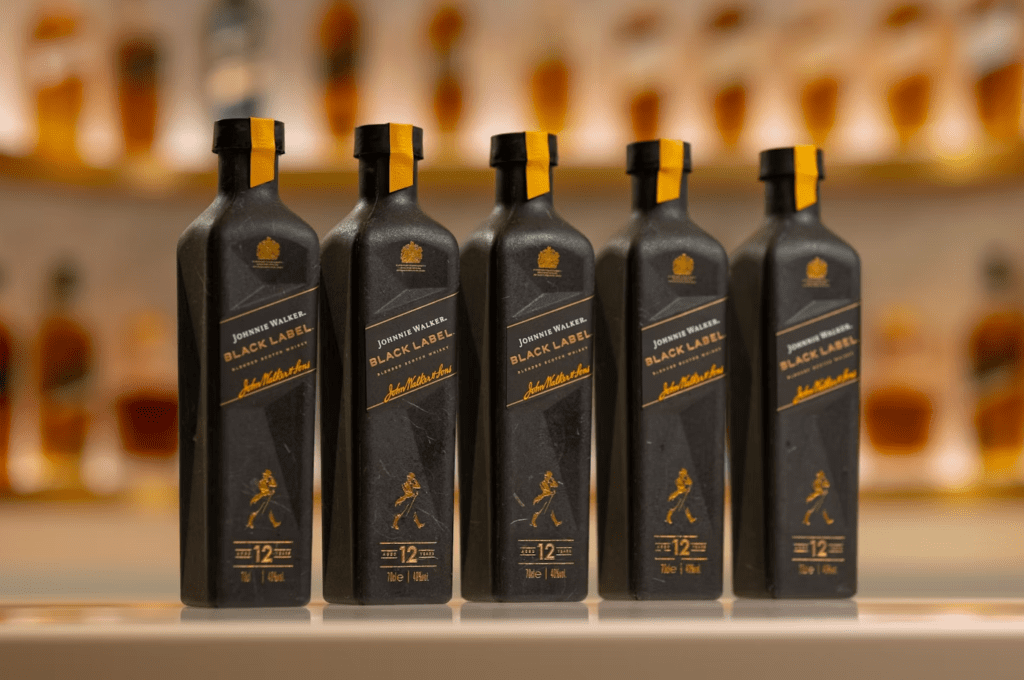 Paper bottle designed to resemble a Johnnie Walker whisky bottle, showcasing eco-friendly packaging.