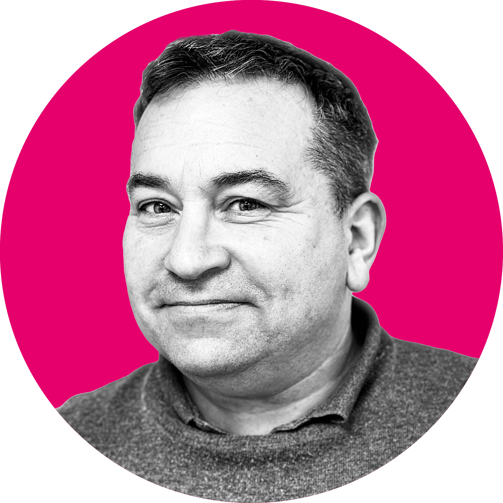 Smiling middle-aged man with short dark hair, wearing a sweater, on a bright pink circular background.